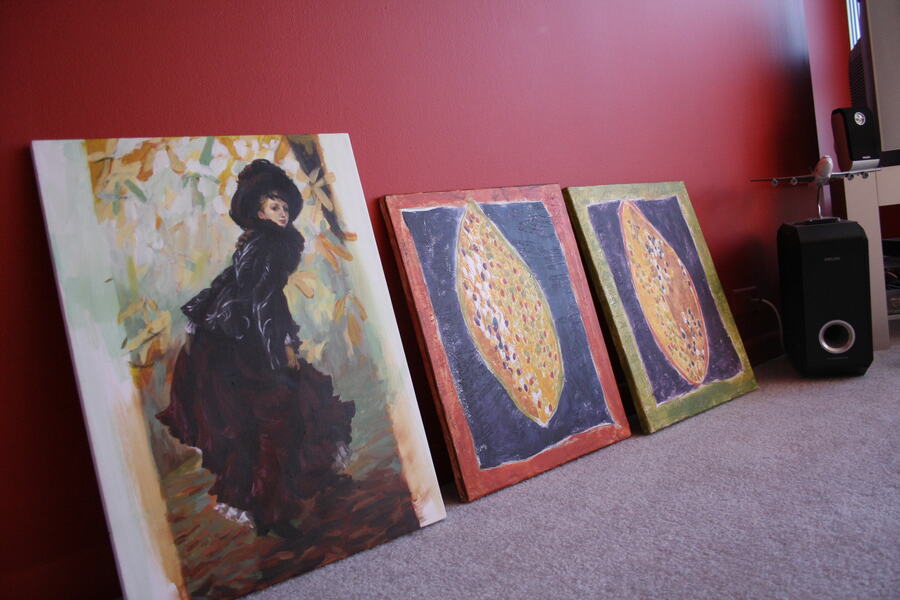 Studio view — an oil study and two leaf-form paintings leaning against a wall