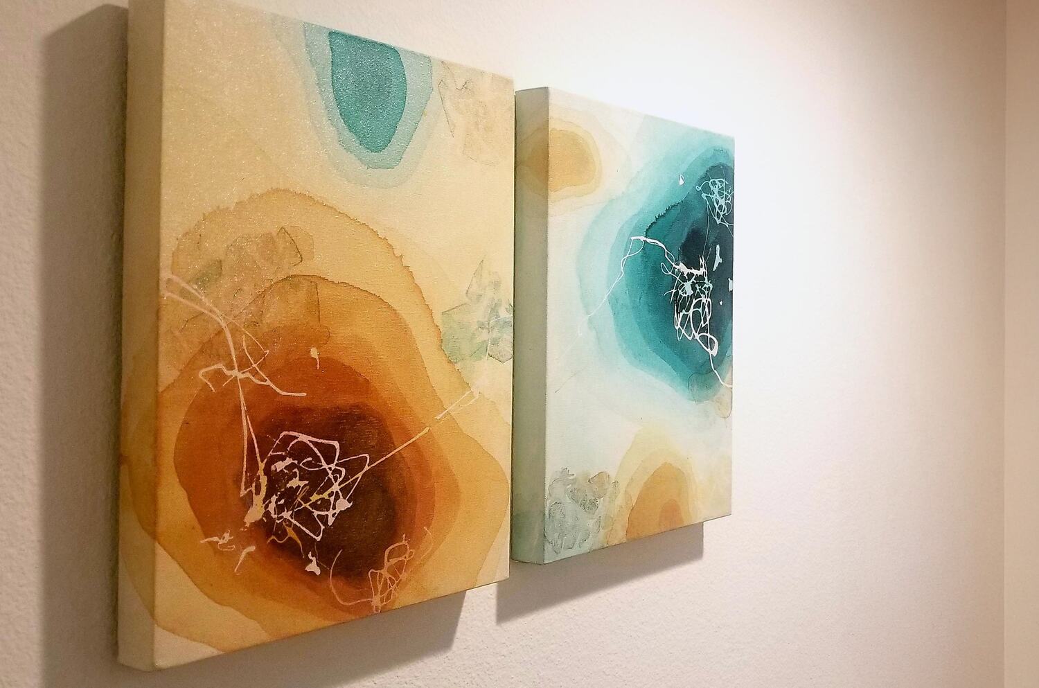 Feel the Fate, 2008 — the two canvases on a gallery wall seen at an angle, raking light catching the layered surface and the painted edges