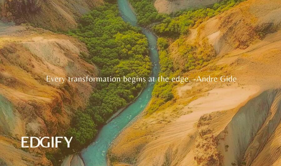 Identity study — an aerial view of a turquoise river cutting a green seam through ochre canyon walls